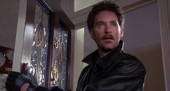 Movie still from “A Fish Called Wanda” (1988), directed by Charles Crichton – A person standing in front of a door; Close Up shot, Low angle