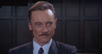 Movie still from “A Fish Called Wanda” (1988), directed by Charles Crichton – A person wearing a suit and tie; Close Up shot, Low angle