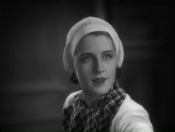 Movie still from “A Free Soul” (1931), directed by Clarence Brown – A black and white photo of a woman wearing a hat; Close Up shot, Low angle