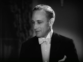 Movie still from “A Free Soul” (1931), directed by Clarence Brown – A man wearing a tuxedo and a bow tie; Close Up shot, Low angle