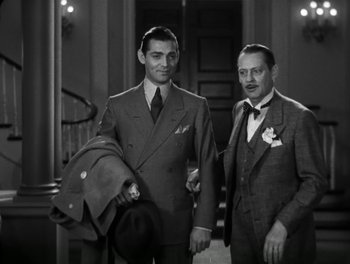 Movie still from “A Free Soul” (1931), directed by Clarence Brown – Two men in suits posing for a picture; Medium shot, Low angle