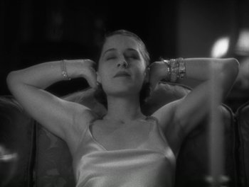 Movie still from “A Free Soul” (1931), directed by Clarence Brown – A beautiful young lady laying on top of a chair; Close Up shot, Low angle