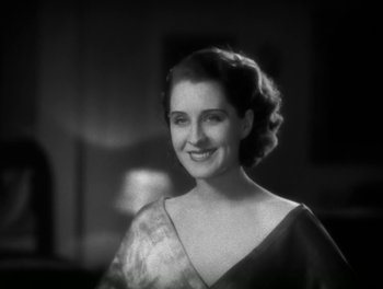 Movie still from “A Free Soul” (1931), directed by Clarence Brown – An old photo of a woman smiling for the camera; Close Up shot, Low angle
