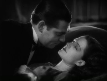 Movie still from “A Free Soul” (1931), directed by Clarence Brown – A black and white photo of a man and a woman kissing; Close Up shot, High angle