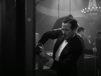 Movie still from “A Free Soul” (1931), directed by Clarence Brown – A black and white photo of a man in a tuxedo; Medium shot, High angle