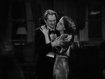 Movie still from “A Free Soul” (1931), directed by Clarence Brown – A man and a woman embracing in a black and white photo; Medium shot, Low angle