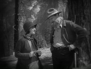 Movie still from “A Free Soul” (1931), directed by Clarence Brown – An old photo of a man and a woman in the woods; Medium shot, High angle