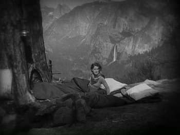 Movie still from “A Free Soul” (1931), directed by Clarence Brown – An old photo of a woman sitting on the ground; Wide shot, High angle