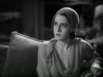 Movie still from “A Free Soul” (1931), directed by Clarence Brown – A black and white photo of a woman wearing a hat; Close Up shot, High angle