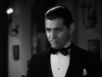 Movie still from “A Free Soul” (1931), directed by Clarence Brown – A man in a suit and bow tie; Close Up shot, Low angle