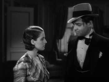 Movie still from “A Free Soul” (1931), directed by Clarence Brown – A man and a woman standing next to each other in a room; Medium shot, High angle