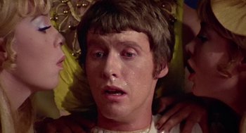 Movie still from “A Funny Thing Happened on the Way to the Forum” (1966), directed by Richard Lester – A young man is crying while being comforted by a woman; Close Up shot, Low angle
