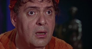 Movie still from “A Funny Thing Happened on the Way to the Forum” (1966), directed by Richard Lester – A person wearing an orange shirt; Close Up shot, Low angle