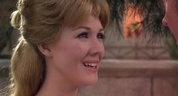 Movie still from “A Funny Thing Happened on the Way to the Forum” (1966), directed by Richard Lester – A woman's smiling face; Close Up shot, Over the shoulder angle