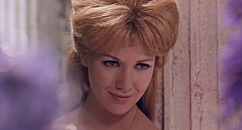 Movie still from “A Funny Thing Happened on the Way to the Forum” (1966), directed by Richard Lester – A person wearing a dress; Close Up shot, Low angle