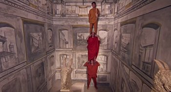 Movie still from “A Funny Thing Happened on the Way to the Forum” (1966), directed by Richard Lester – Three men in ancient roman garb pose for a picture; Wide shot, Overhead angle