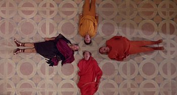 Movie still from “A Funny Thing Happened on the Way to the Forum” (1966), directed by Richard Lester – A group of people laying on the ground; Wide shot, Overhead angle