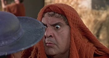 Movie still from “A Funny Thing Happened on the Way to the Forum” (1966), directed by Richard Lester – A man with a towel on his head looking into a mirror; Close Up shot, Over the shoulder angle
