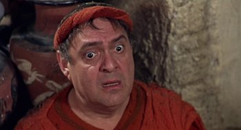 Movie still from “A Funny Thing Happened on the Way to the Forum” (1966), directed by Richard Lester – A person wearing a red shirt; Close Up shot, Low angle