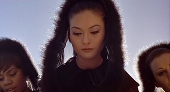Movie still from “A Funny Thing Happened on the Way to the Forum” (1966), directed by Richard Lester – A young woman with a fur trimmed hooded jacket; Close Up shot, Low angle