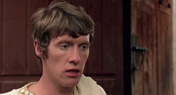 Movie still from “A Funny Thing Happened on the Way to the Forum” (1966), directed by Richard Lester – A person wearing a white shirt; Close Up shot, Low angle