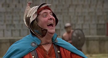 Movie still from “A Funny Thing Happened on the Way to the Forum” (1966), directed by Richard Lester – A man wearing a helmet and a red and blue outfit; Close Up shot, Low angle