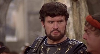 Movie still from “A Funny Thing Happened on the Way to the Forum” (1966), directed by Richard Lester – A person with a beard; Close Up shot, Low angle