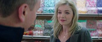 A woman is talking to a man in a candy store