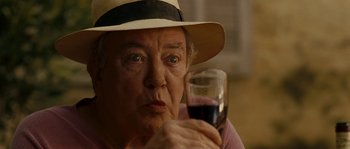 Movie still from “A Good Year” (2006), directed by Ridley Scott – An older woman holding a glass of wine; Close Up shot, Over the shoulder angle