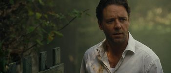 Movie still from “A Good Year” (2006), directed by Ridley Scott – A person wearing a white shirt near a tree; Close Up shot, Over the shoulder angle