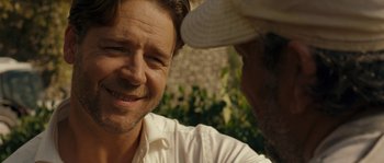 Movie still from “A Good Year” (2006), directed by Ridley Scott – A man in a white shirt and a man in a white hat; Close Up shot, Over the shoulder angle