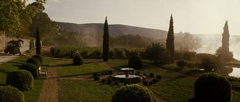 Movie still from “A Good Year” (2006), directed by Ridley Scott – A person standing in the middle of a garden; Extreme Wide shot, High angle