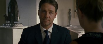 Movie still from “A Good Year” (2006), directed by Ridley Scott – A person wearing a suit and tie; Close Up shot, Over the shoulder angle