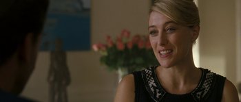 Movie still from “A Good Year” (2006), directed by Ridley Scott – A beautiful blonde woman smiling for the camera; Close Up shot, Over the shoulder angle