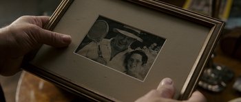 Movie still from “A Good Year” (2006), directed by Ridley Scott – An old photo of a man and a woman holding tennis rackets; Extreme Close Up shot, Overhead angle