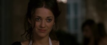 Movie still from “A Good Year” (2006), directed by Ridley Scott – A woman's face in a dark room; Close Up shot, Over the shoulder angle