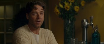 Movie still from “A Good Year” (2006), directed by Ridley Scott – A person sitting in a room; Close Up shot, Over the shoulder angle