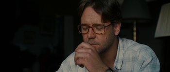 Movie still from “A Good Year” (2006), directed by Ridley Scott – A person wearing glasses and holding his hand to his face; Close Up shot, Over the shoulder angle