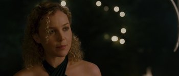 Movie still from “A Good Year” (2006), directed by Ridley Scott – A woman with curly blonde hair wearing a black top; Close Up shot, Over the shoulder angle