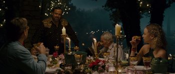Movie still from “A Good Year” (2006), directed by Ridley Scott – Two men sitting at a dinner table with candles; Medium shot, Over the shoulder angle