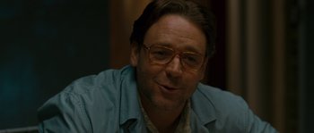 Movie still from “A Good Year” (2006), directed by Ridley Scott – A person wearing glasses and smiling; Close Up shot, Over the shoulder angle