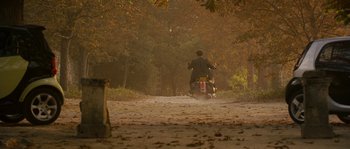 Movie still from “A Good Year” (2006), directed by Ridley Scott – A man riding a motorcycle down a dirt road; Extreme Wide shot, High angle
