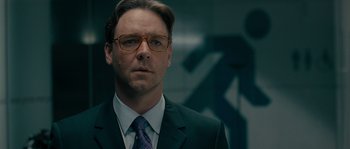 Movie still from “A Good Year” (2006), directed by Ridley Scott – A person wearing a suit and glasses; Close Up shot, Over the shoulder angle