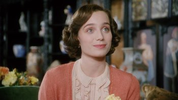 Movie still from “A Handful of Dust” (1988), directed by Charles Sturridge – A person wearing a dress; Close Up shot, Over the shoulder angle