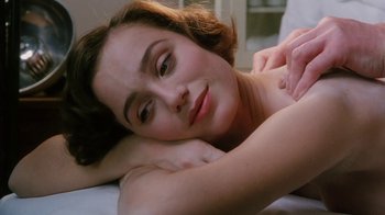 Movie still from “A Handful of Dust” (1988), directed by Charles Sturridge – A beautiful young lady laying on top of a bed; Close Up shot, High angle