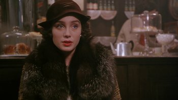 Movie still from “A Handful of Dust” (1988), directed by Charles Sturridge – A woman wearing a hat and a fur coat; Close Up shot, Over the shoulder angle