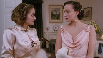Movie still from “A Handful of Dust” (1988), directed by Charles Sturridge – Two young women are talking to each other in a room; Close Up shot, Over the shoulder angle