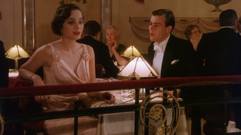 Movie still from “A Handful of Dust” (1988), directed by Charles Sturridge – A man and a woman sitting at a dinner table; Medium shot, Low angle