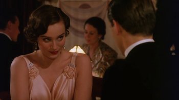 Movie still from “A Handful of Dust” (1988), directed by Charles Sturridge – A man and a woman are talking to each other in front of another man; Close Up shot, Over the shoulder angle