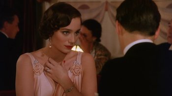 Movie still from “A Handful of Dust” (1988), directed by Charles Sturridge – A beautiful woman in a pink dress and a man in a black suit; Close Up shot, Over the shoulder angle